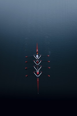a row of boats floating on top of a body of water