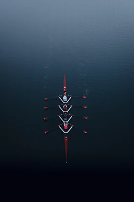 a row of boats floating on top of a body of water