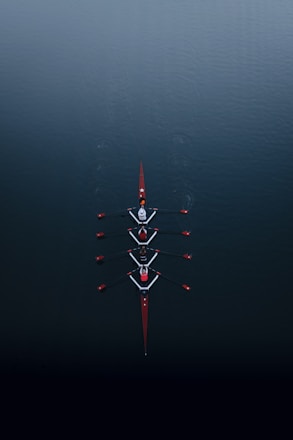 a row of boats floating on top of a body of water