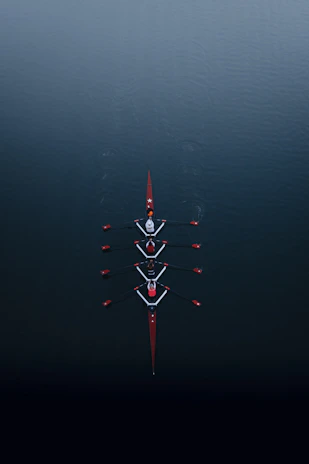 a row of boats floating on top of a body of water