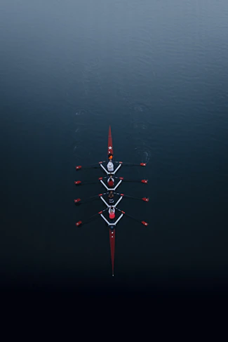 a row of boats floating on top of a body of water