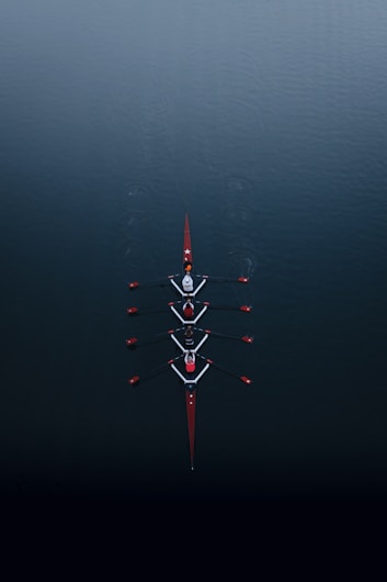 a row of boats floating on top of a body of water