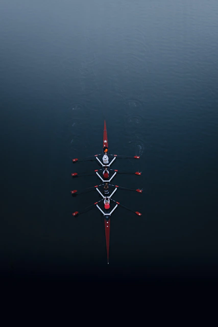 a row of boats floating on top of a body of water