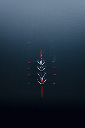 a row of boats floating on top of a body of water
