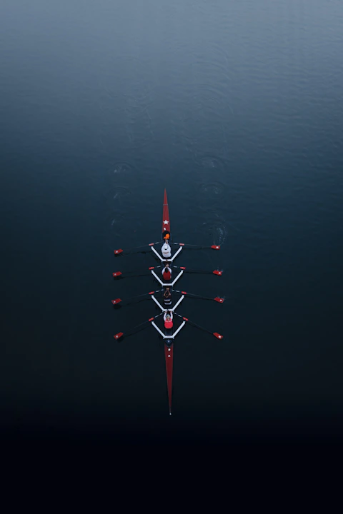 a row of boats floating on top of a body of water