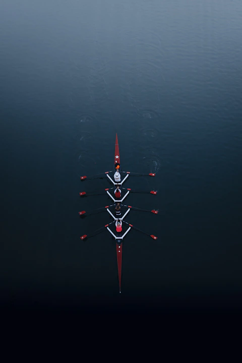 a row of boats floating on top of a body of water