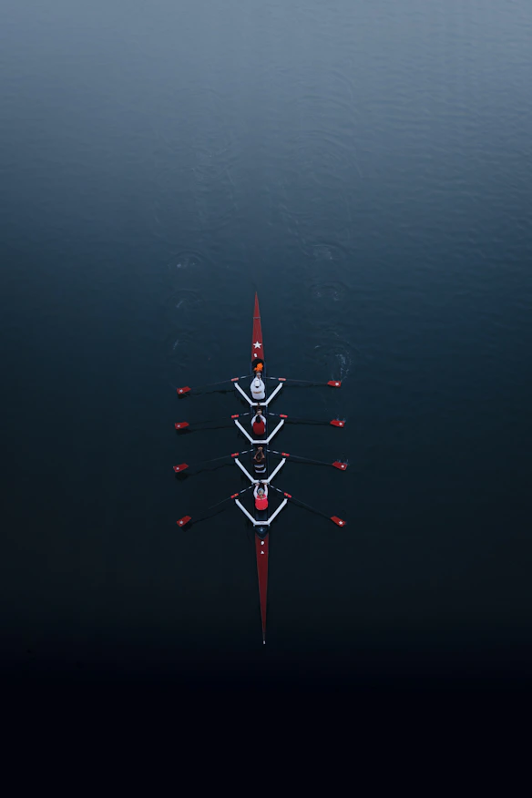 a row of boats floating on top of a body of water