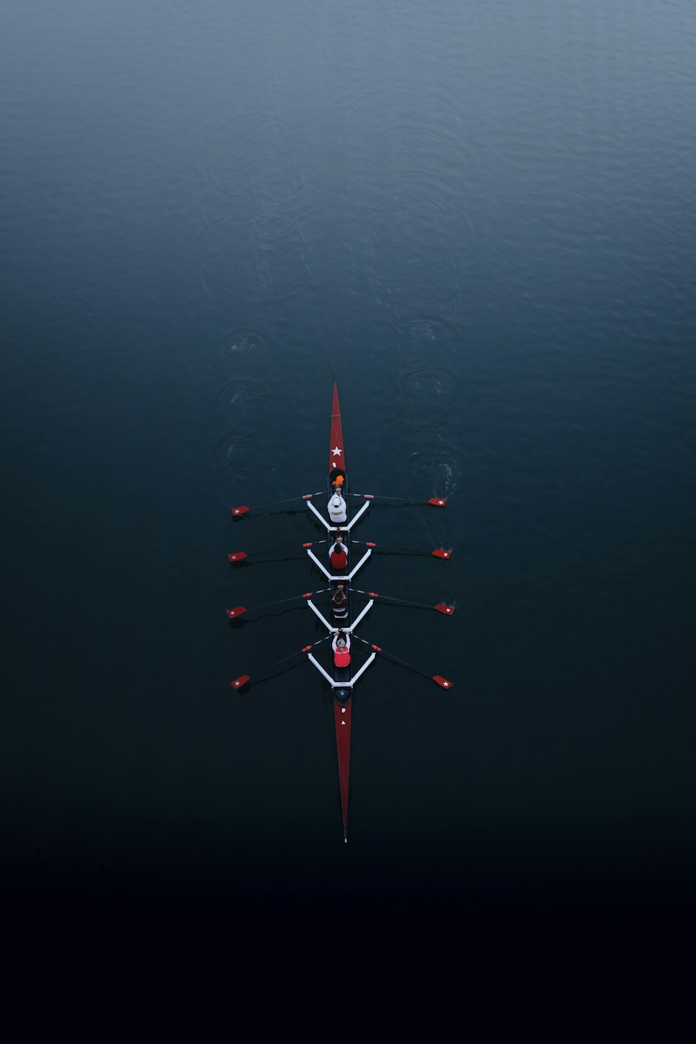a row of boats floating on top of a body of water