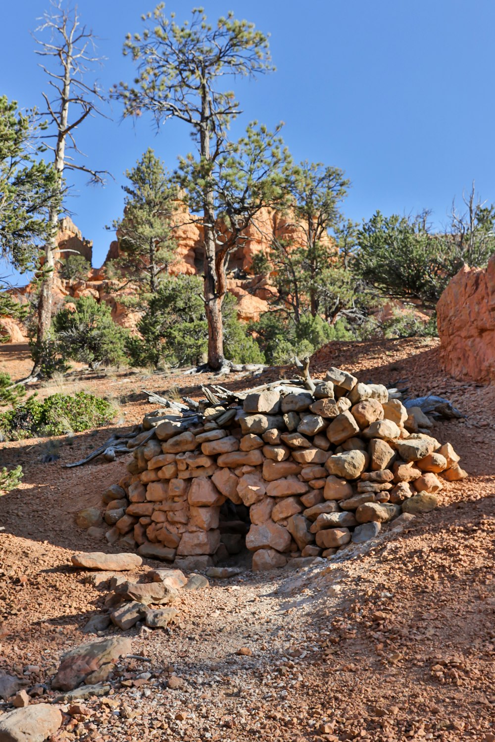 a pile of rocks sitting on top of a dirt field