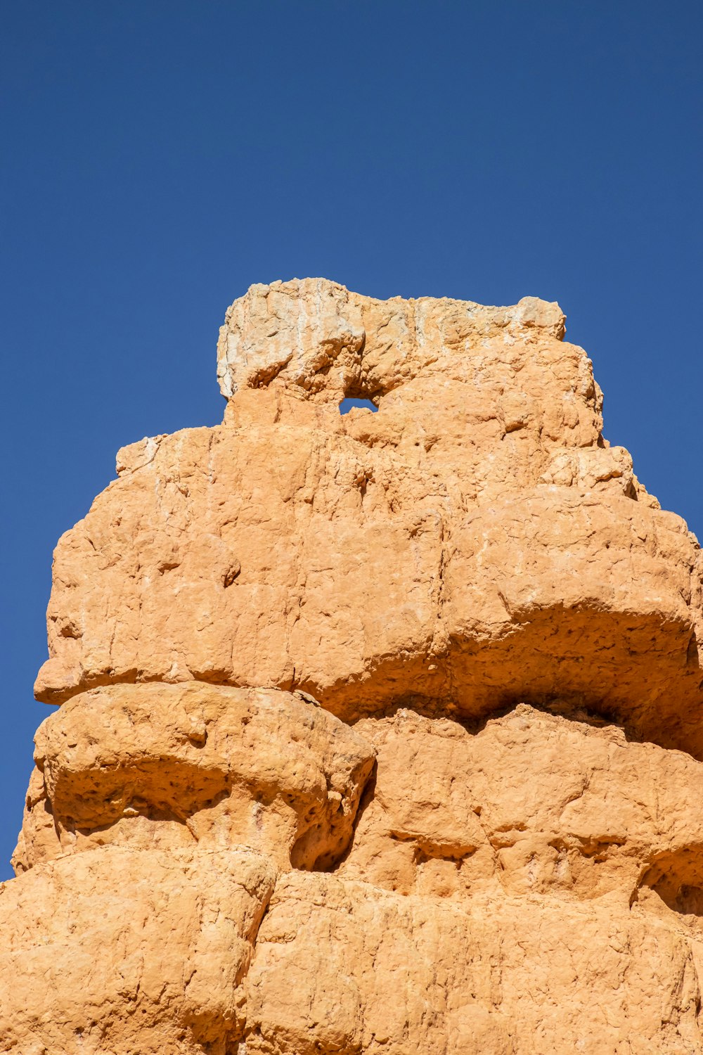 a rock formation with a bird perched on top of it