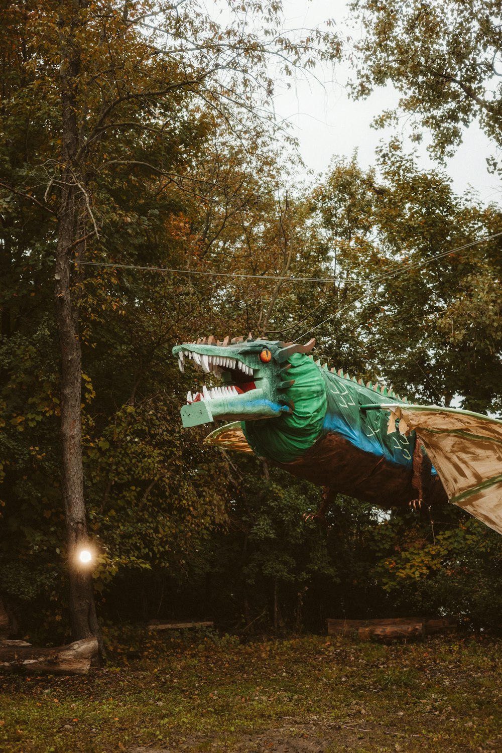 a statue of a green dragon is in the air