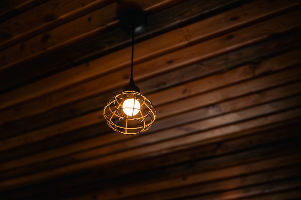 a light bulb hanging from a wooden ceiling