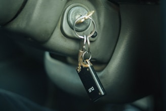 a car door handle with a keychain hanging from it