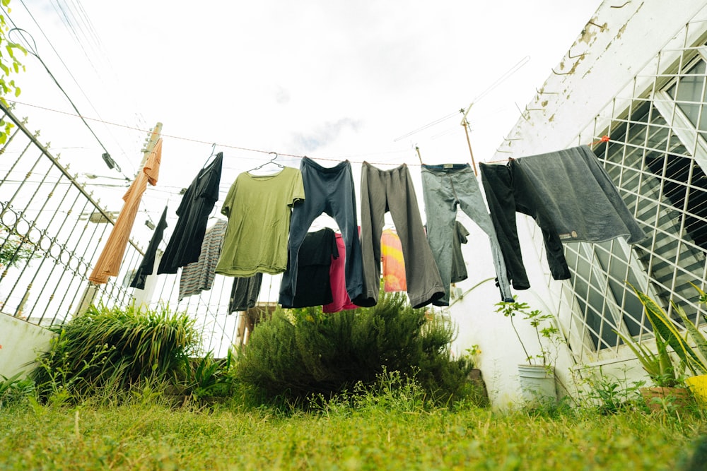 clothes hanging on a clothes line outside a house