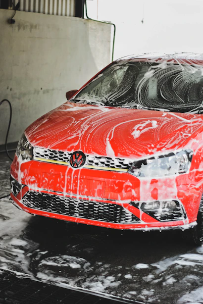 a red car is covered in a lot of snow