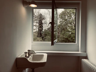 Minimalist interior featuring a custom stone tile sink with soft natural lighting.