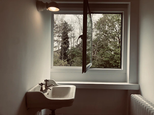 Minimalist interior featuring a custom stone tile sink with soft natural lighting.