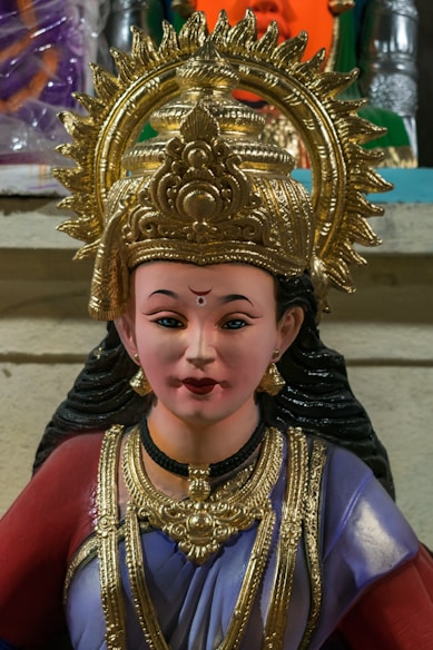 a close up of a statue of a person wearing a headdress