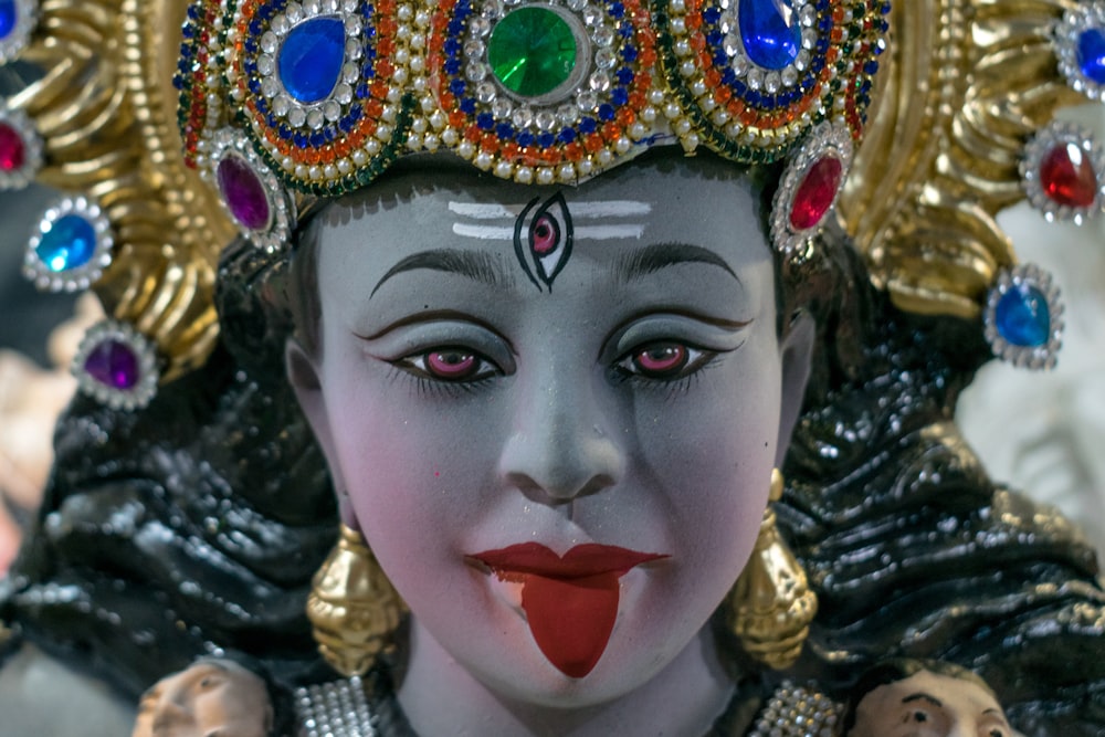 a close up of a statue of a woman wearing a headdress