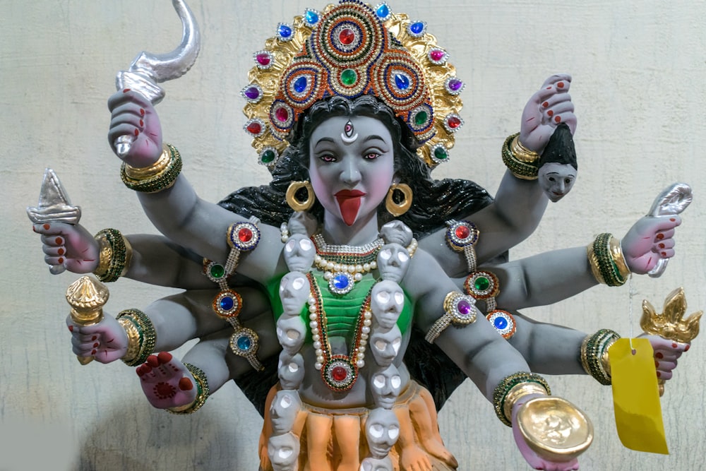 a statue of a hindu god with multiple arms and legs