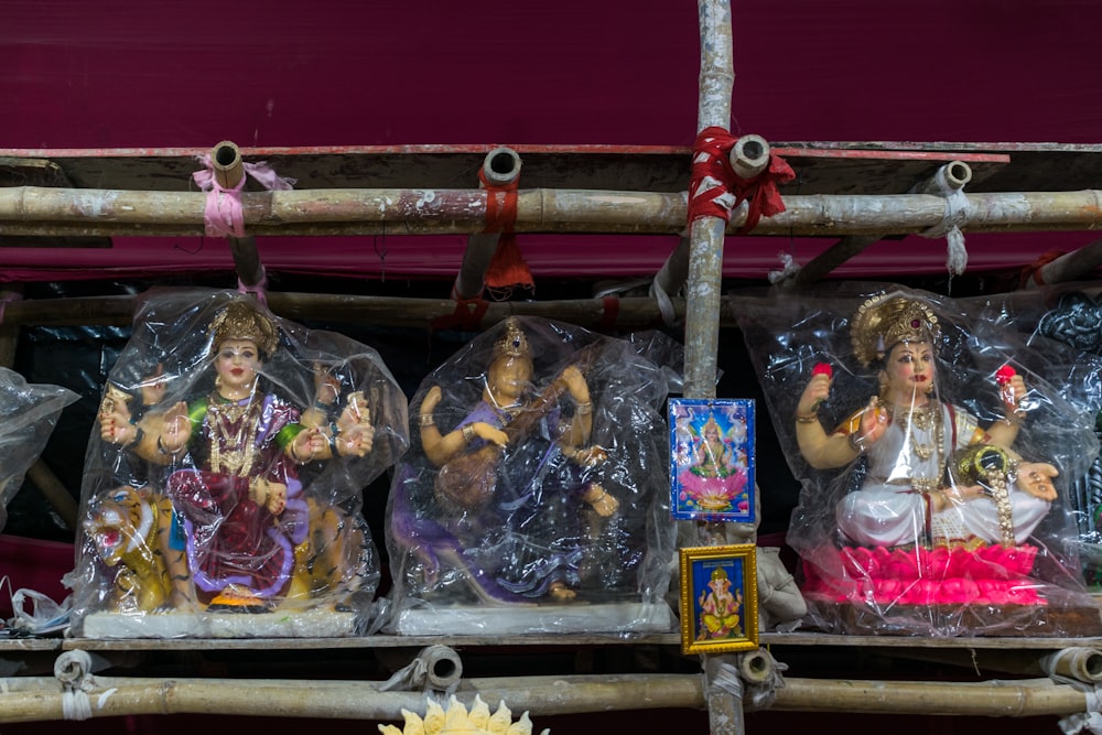 a group of figurines sitting on top of a shelf