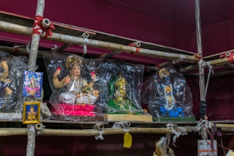 Intricately carved statues representing various orishas on display.