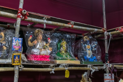 Intricately carved statues representing various orishas on display.