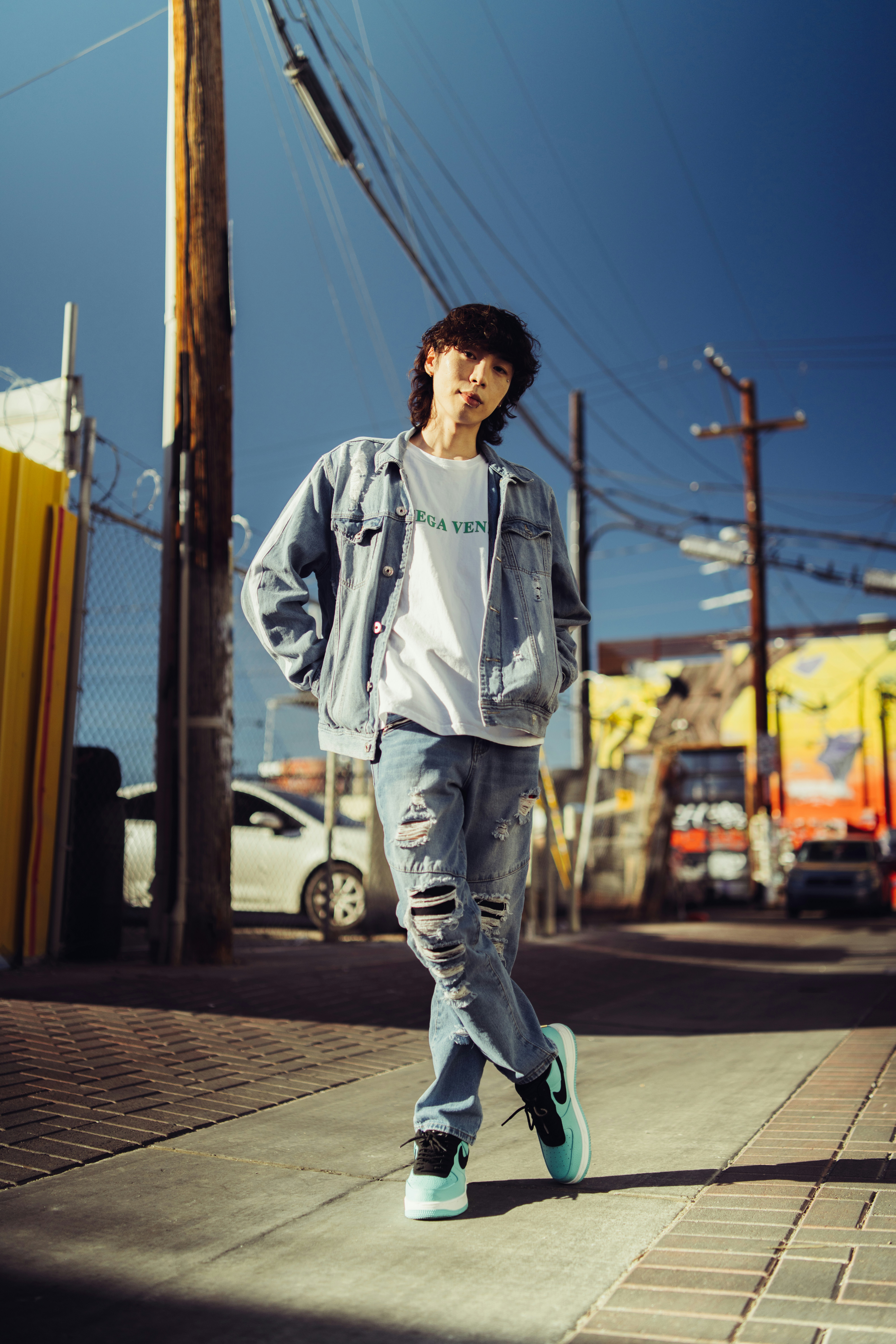 a young man is walking down the street