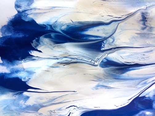 Abstract painting with flowing, swirling patterns in shades of blue and white, resembling ocean waves or clouds.
