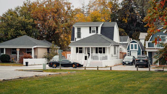 a couple of cars parked in front of a house