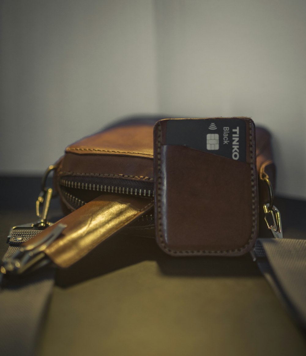 a wallet with a credit card holder on top of it