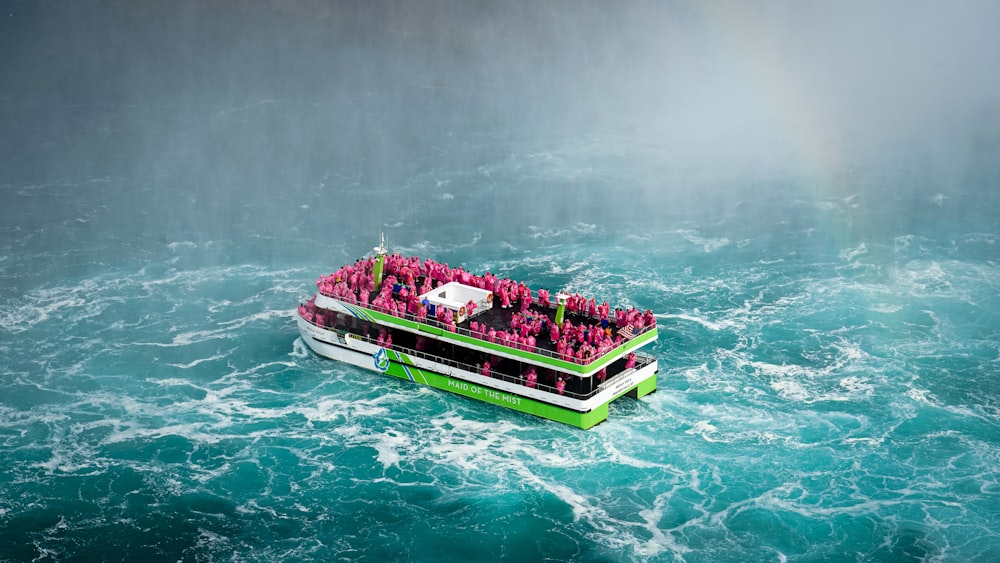 a boat full of people in the middle of a body of water