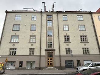 Exterior view of a mixed-use building with neutral colors.