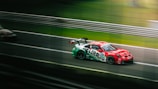 A dynamic racing car speeding on a track.