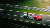 A dynamic shot of a race car speeding around a track, showcasing the thrill of motorsport.