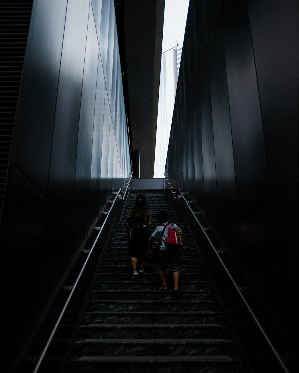 a couple of people that are walking up some stairs