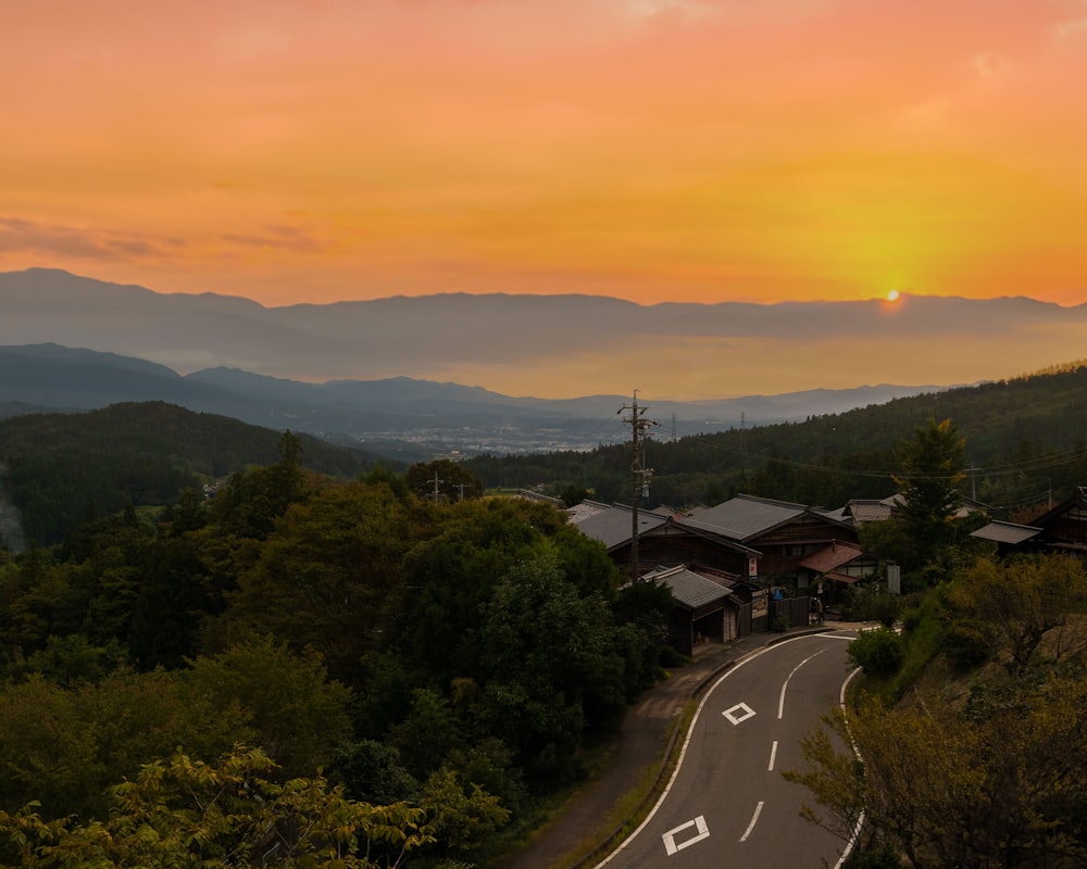 the sun is setting over the mountains in the distance