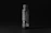 Close-up of a sleek black élánmag bottle with a smartphone magnetically attached, set against a minimalist white background.