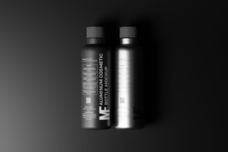 two bottles of shampoo on a black background