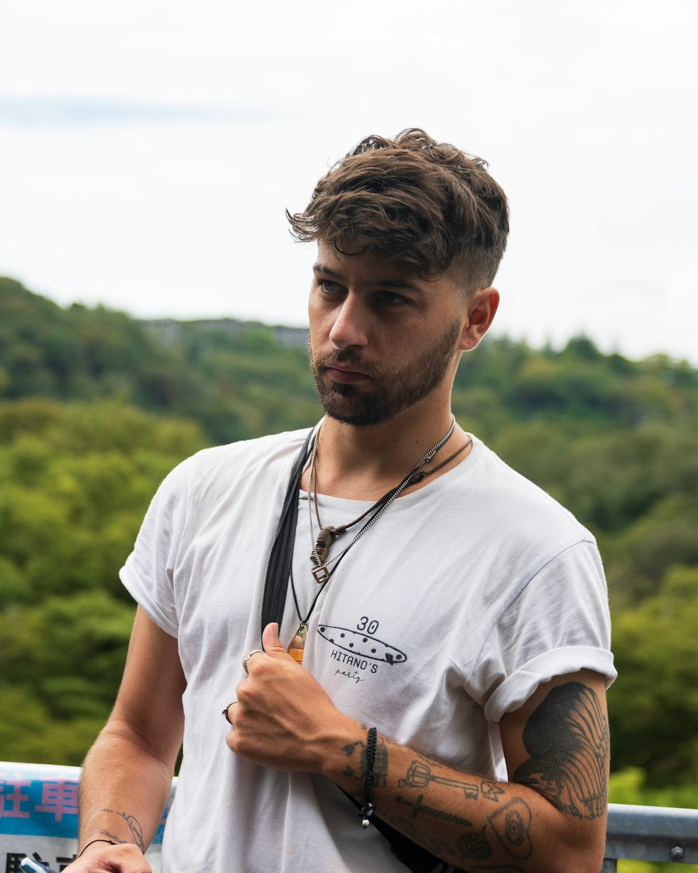 a man with a tattoo on his arm holding a camera