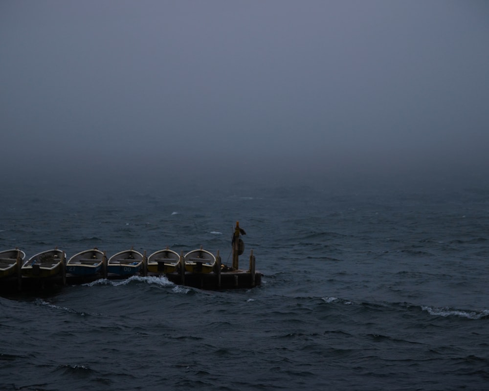 a man standing on a boat in the middle of the ocean