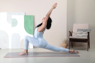 A wellness coach demonstrating yoga poses in a serene, monochrome studio.
