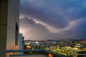Sophisticated cityscape view from a high-rise balcony at dusk
