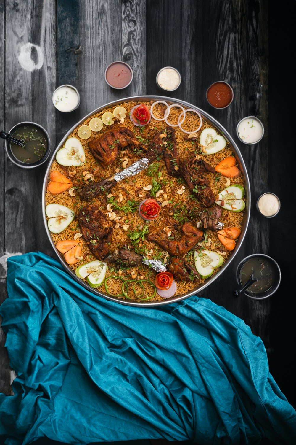 a large platter of food on a wooden table