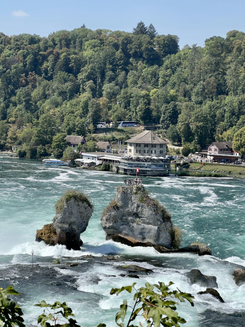 a body of water surrounded by trees and houses