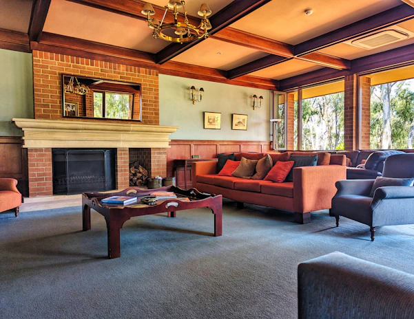 A cozy living room remodel with warm tones, custom built-ins, and large windows letting in natural light.