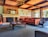 A cozy living room with large windows and comfortable seating, perfect for relaxation.