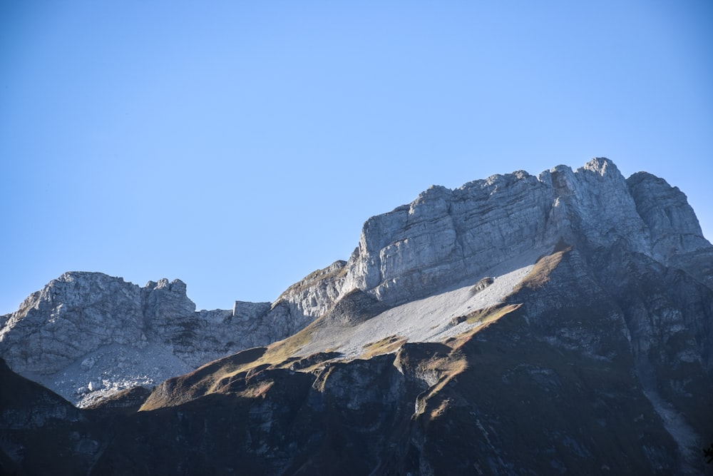 a view of a mountain with a clear blue sky