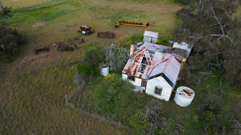 an aerial view of a house in the middle of a field