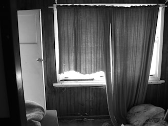 A mysterious, dimly lit room with scattered old letters and a flickering candle casting shadows.